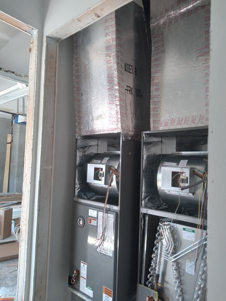Two new air handlers with new insulated ductwork at a new-construction home