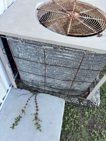 Old, rusted outdoor AC condenser at the end of its service life